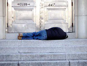 A Man Sleeping on a Stone Stairwell, North Philadelphia, PA