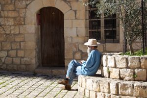 A Man Sits in a Public Square in Safed, Israel